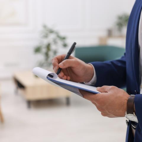 Man writing on a clipboard