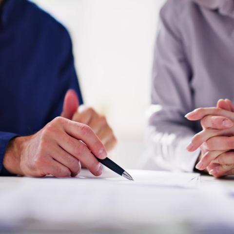 two people overlooking paperwork